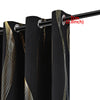 Two black blackout curtains with a golden wave pattern hanging from a rod.