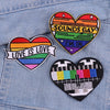Three heart-shaped embroidered patches featuring rainbow colors and text like Sounds Gay I'm In and Love Is Love