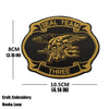 A black embroidered armband patch with gold lettering and an eagle design, featuring the text Seal Team and THREE.