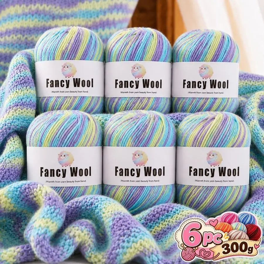 A set of six balls of fancy wool yarn in various pastel gradients, displayed next to knitted fabric.