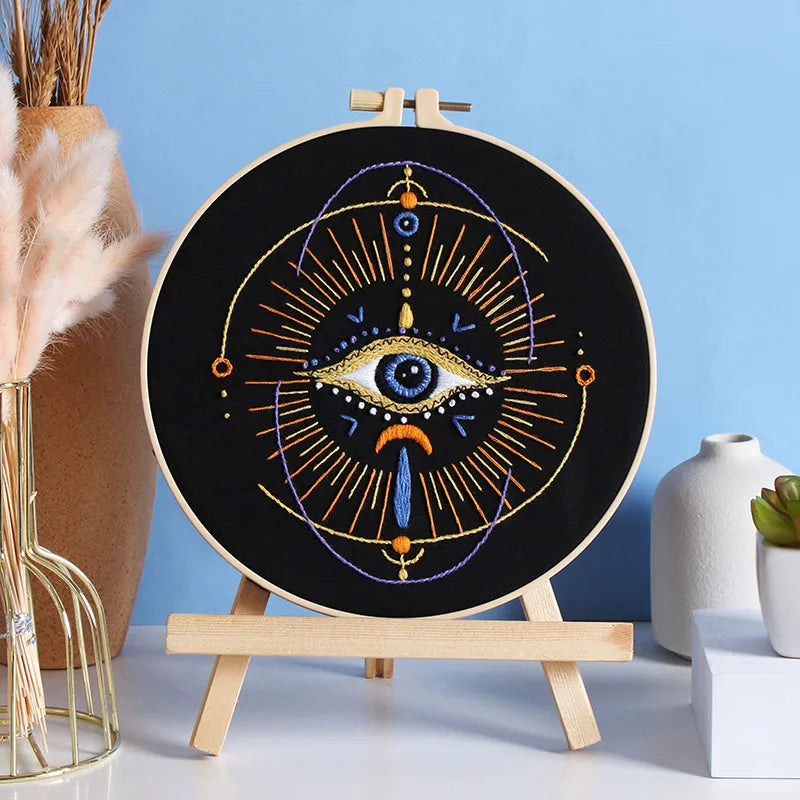 A beginner embroidery starter kit featuring star patterns displayed on a circular wooden board.