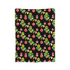 A dark background blanket featuring a repeating pattern of red and green Christmas ornaments.