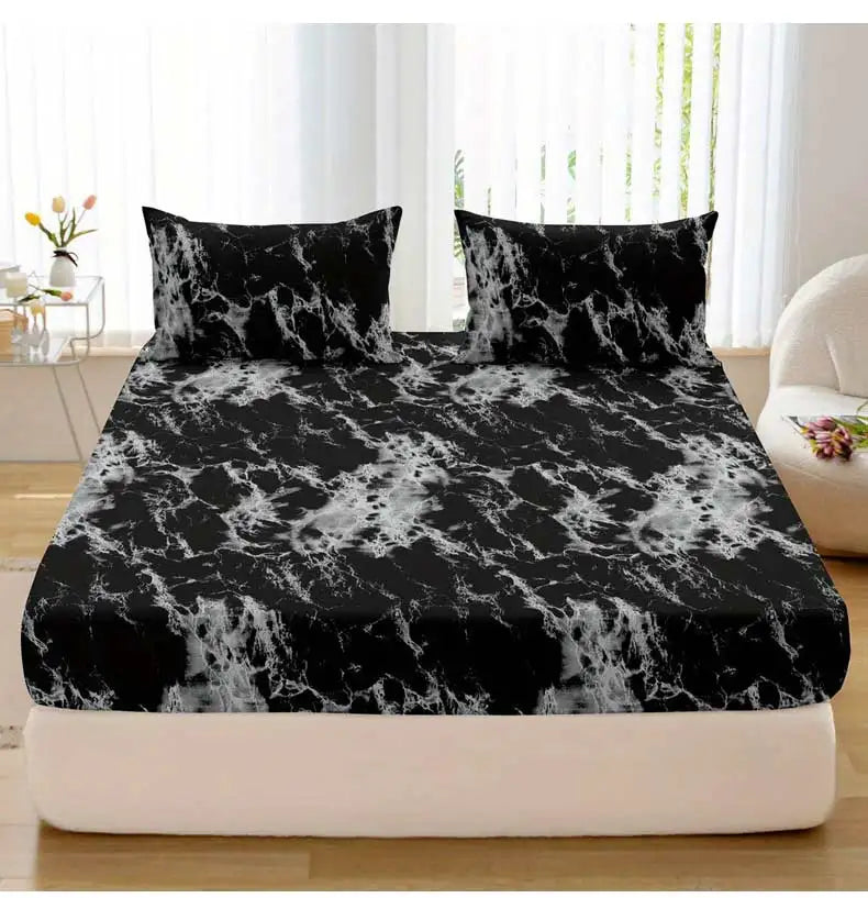 Black and white marble print fitted sheet set with pillowcases on a bed