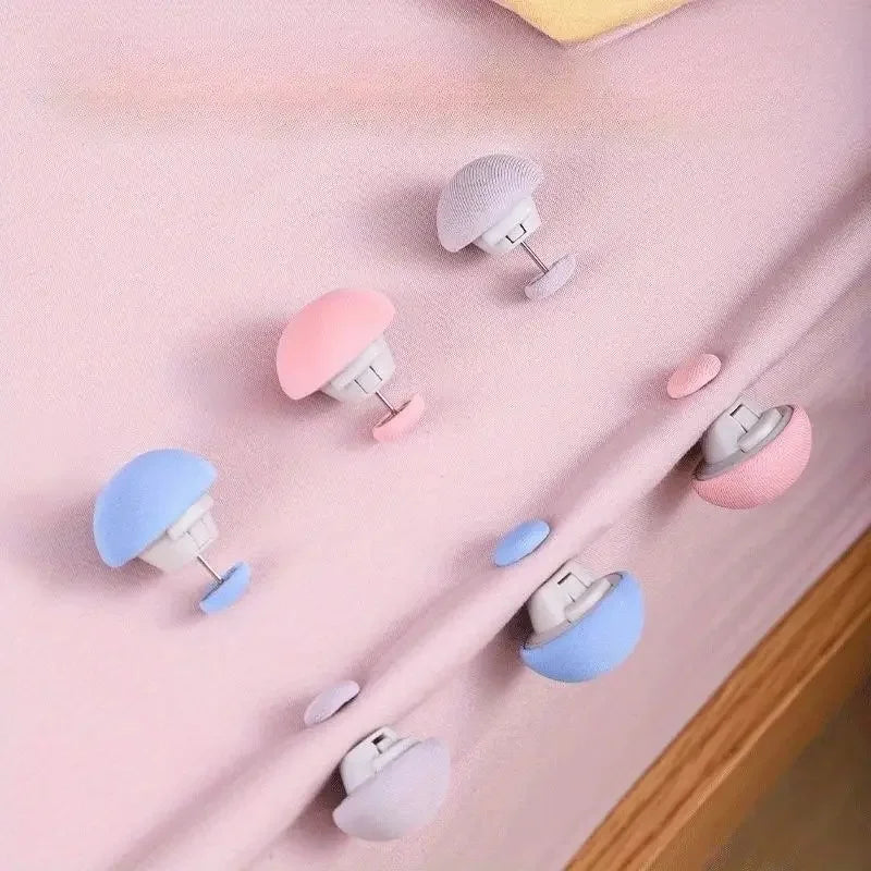 A collection of no-sew silicone quilt clips in various pastel colors including pink, purple, and blue, displayed on a pink fa