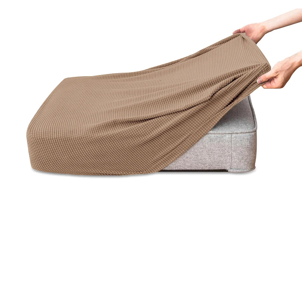 A beige polar fleece jacquard sofa seat cushion cover being held by a hand.
