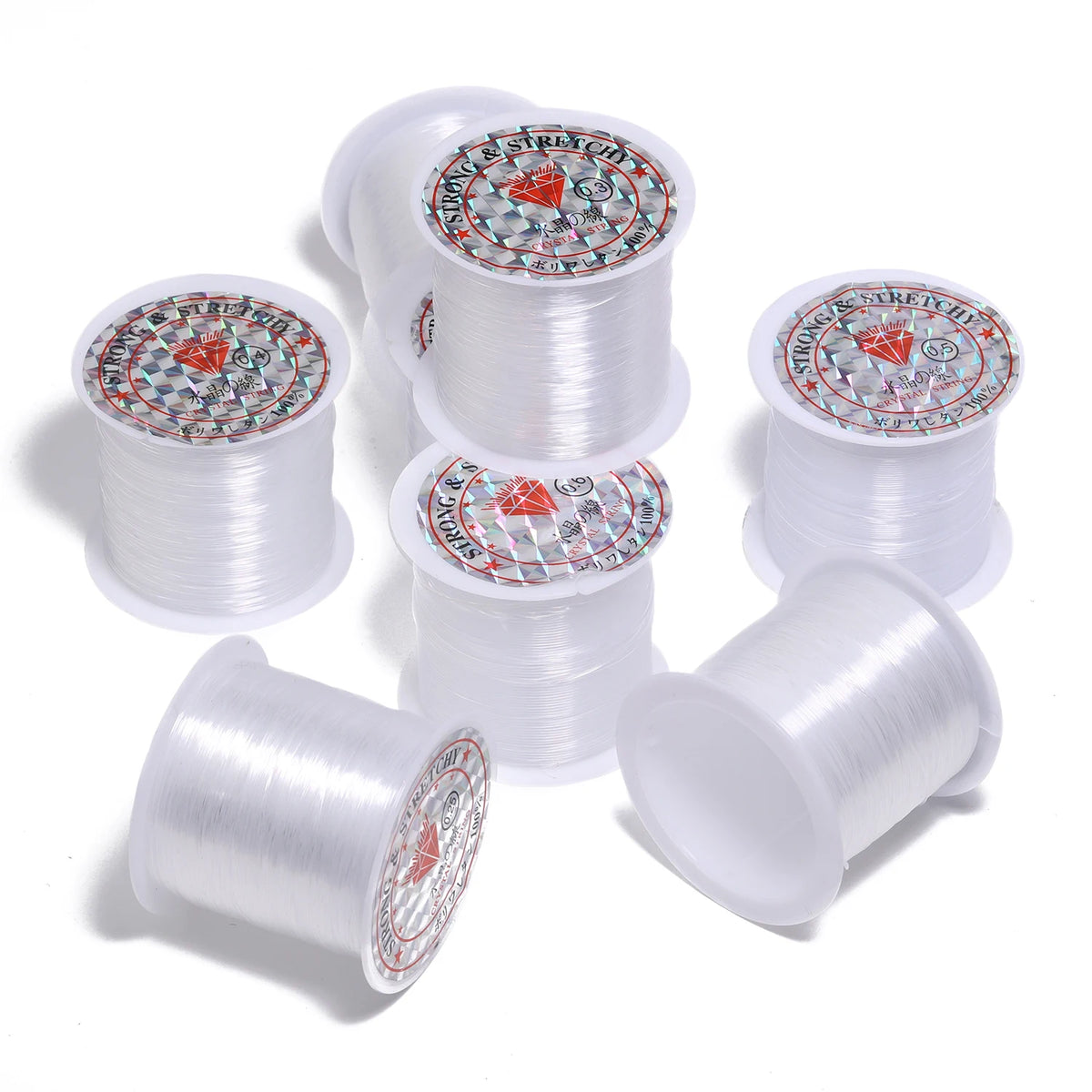Rolls of precision nylon beading thread for jewelry making in white and red packaging