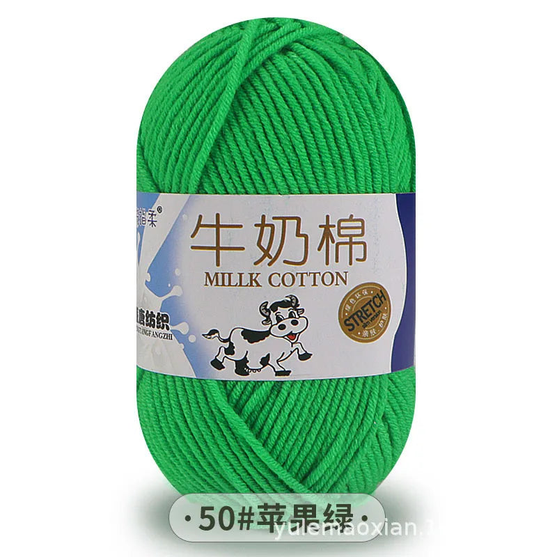 A ball of bright green millk cotton yarn with a label in Chinese and English.