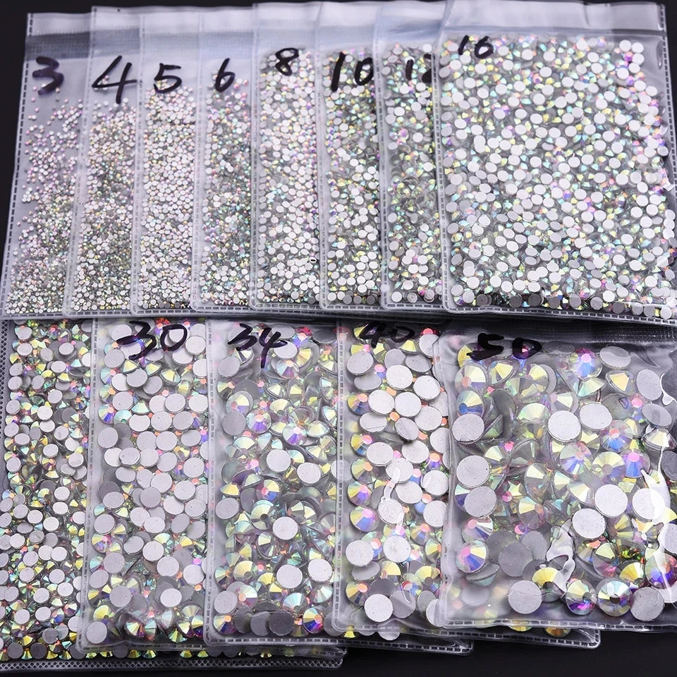 A collection of flatback rhinestones in various colors and sizes packaged in clear plastic bags.