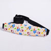 Black adjustable baby car seat head support with a patterned fabric cover