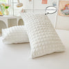 A white quilted pillow is shown next to a white duvet cover, with a label indicating it is without a pillow core.