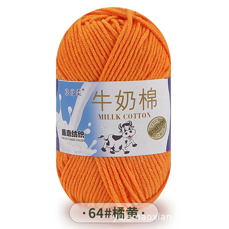 A ball of bright orange milk cotton yarn labeled with Chinese characters and a number 64