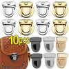 Ten gold metal twist locks for bags and cases shown in various styles.