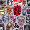 A collection of embroidery patches featuring skulls, roses, and punk themes for clothing.