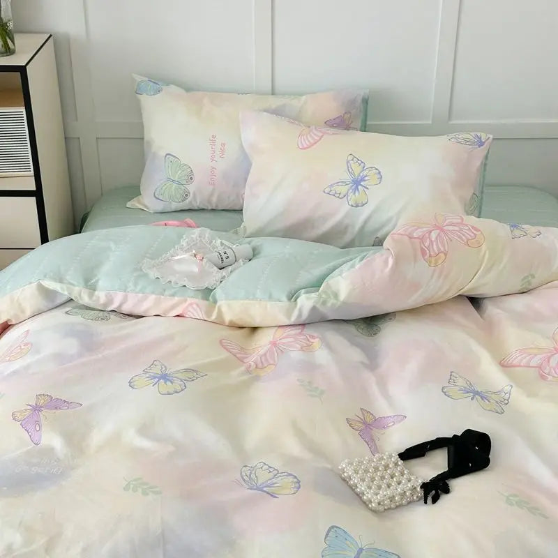 Pink floral bedding set featuring light pink and white fabric with butterfly patterns.