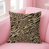A decorative pillow cover featuring a black and tan leopard print on a pink sofa.