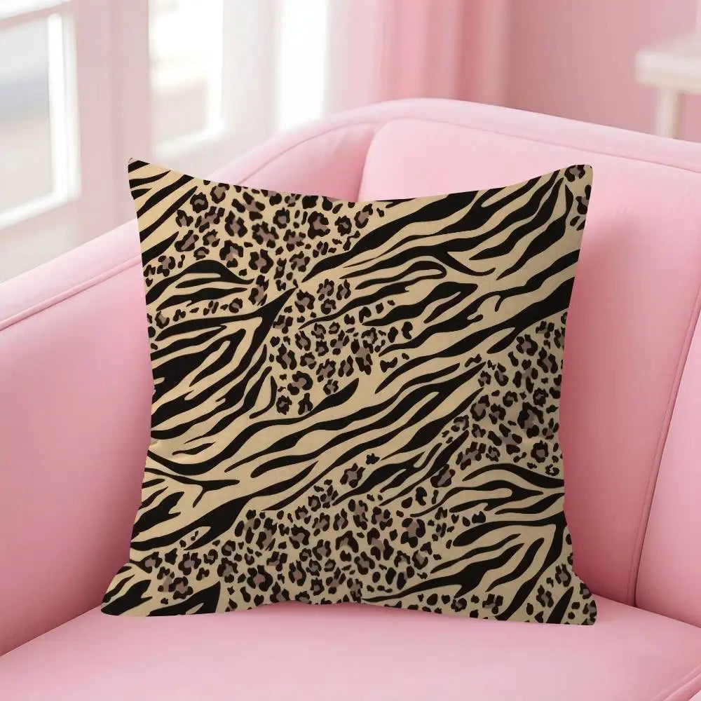 A decorative pillow cover featuring a black and tan leopard print on a pink sofa.