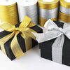 Rolls of gold and silver glitter organza ribbon used for gift wrapping and DIY crafts