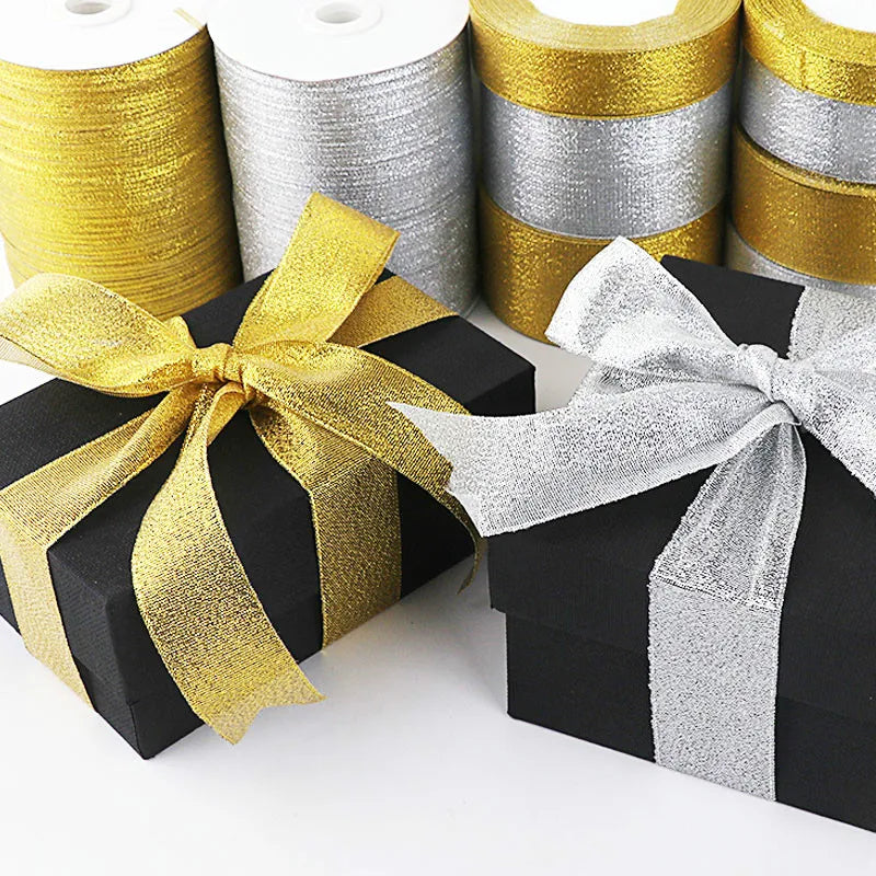Rolls of gold and silver glitter organza ribbon used for gift wrapping and DIY crafts
