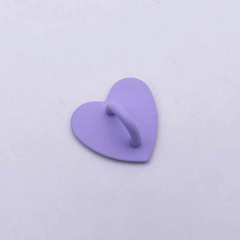 A small, purple heart-shaped metal phone charm connector.