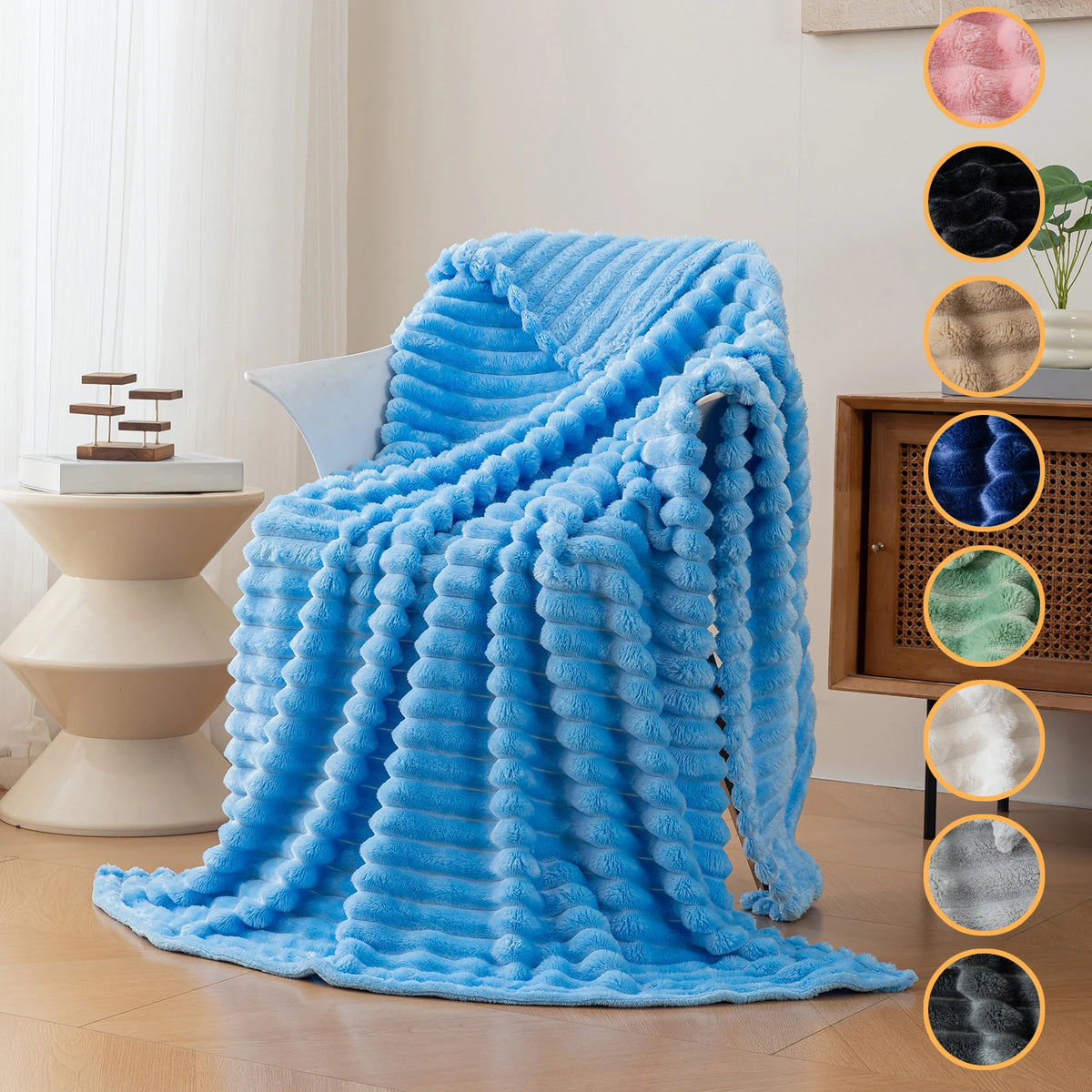 A bright blue soft flannel throw blanket draped on a light-colored surface.