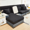 A dark gray Jacquard sofa slipcover with elastic edges shown in a living room setting.