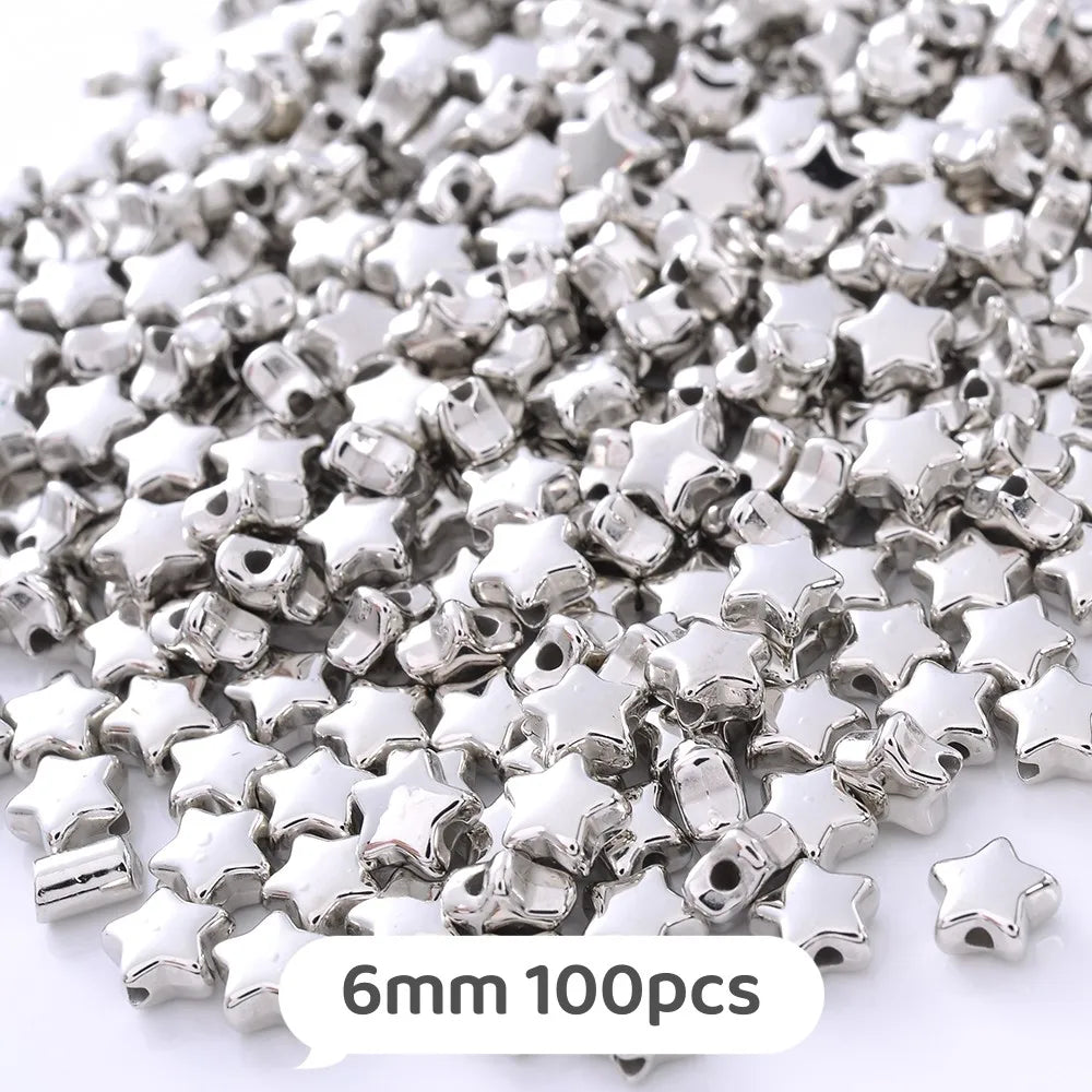 A pile of silver star-shaped metal beads, 6mm size, for jewelry making.