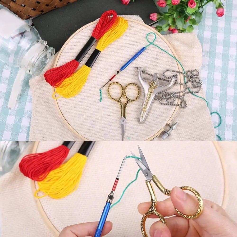 A hand holds vintage stainless steel sewing scissors and embroidery thread on a light fabric background.