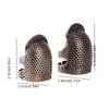 A set of antique sewing thimbles and needle protectors, showing a small S and M size thimble.
