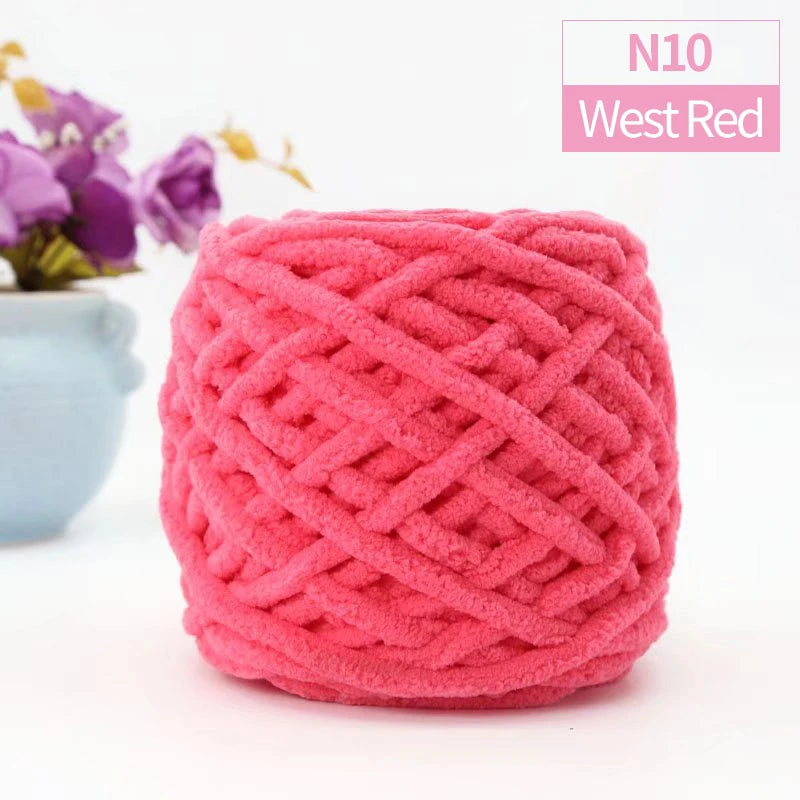 A ball of bright pink West Red chunky velvet knitting yarn for home decor.