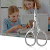 Pair of premium stainless steel embroidery scissors being used by a girl for sewing or crafting.