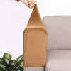 A brown velvet sofa armrest cover is being held by a hand, resting on a light gray sofa.