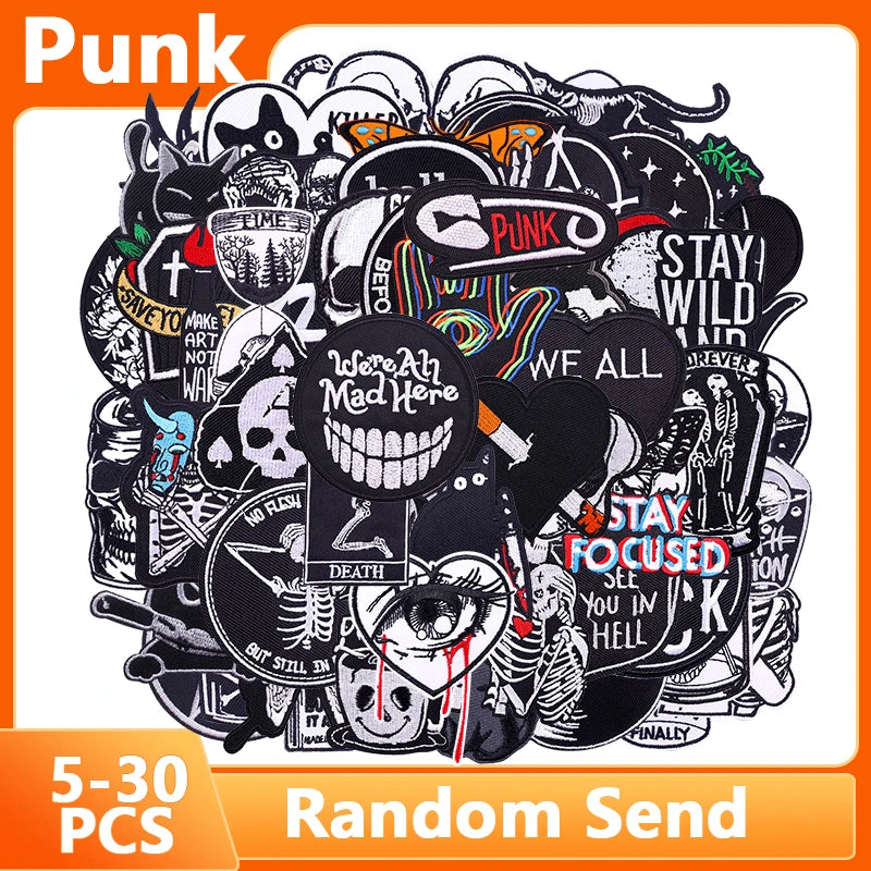 A pile of black embroidered punk patches and pins for DIY clothing