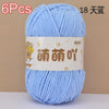 A skein of light blue soft bulky chenille yarn labeled as 6 pieces and 18 strands.