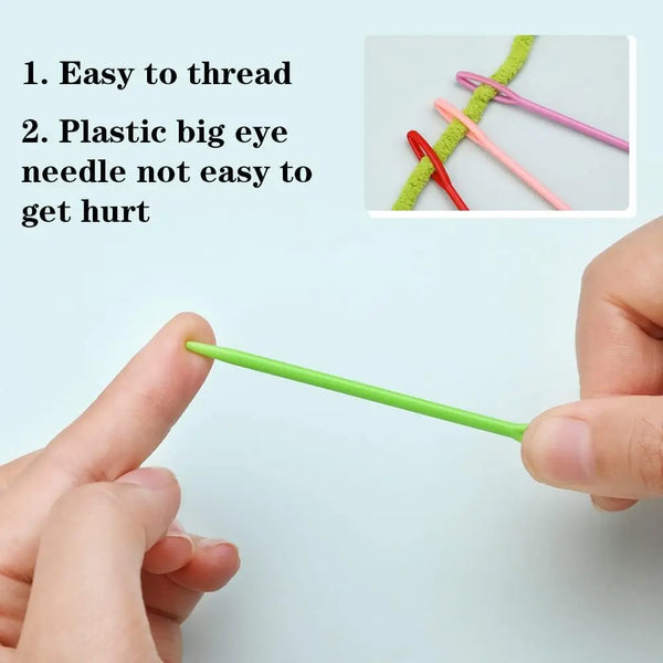 A hand holds a bright green plastic sewing needle with a large eye, demonstrating its ease of threading.