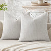 A light gray breathable chenille pillow cover with a minimalist design resting on a white surface.