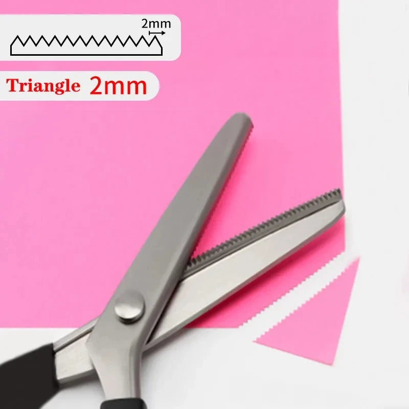 Stainless steel sewing scissors with a zig zag edge shown against pink paper.