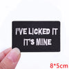 Black embroidered patch with white text that reads I've licked it it's mine