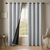 A pair of gray linen blackout curtains hanging in a window frame.