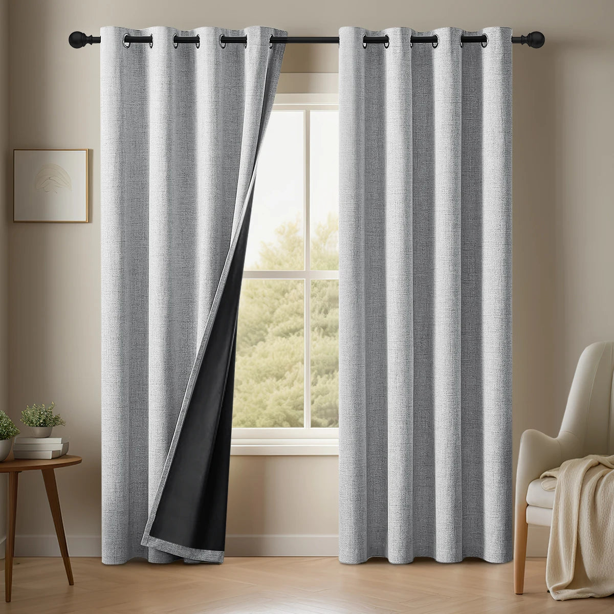 A pair of gray linen blackout curtains hanging in a window frame.