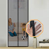 A magnetic screen door curtain installed in a glass frame, showing a person sitting and a soccer ball.
