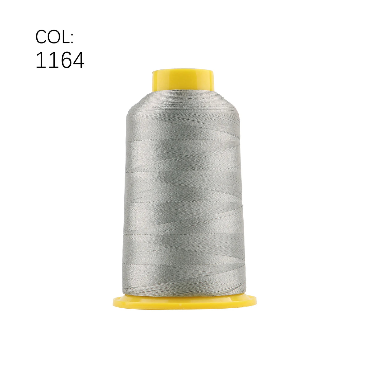 A spool of silver embroidery thread with a yellow cap.