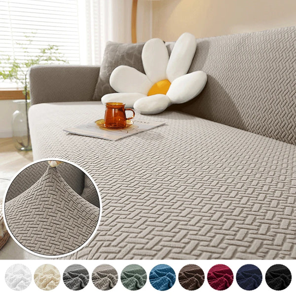 A thick gray jacquard sofa cover featuring white decorative pillows and a textured weave pattern.