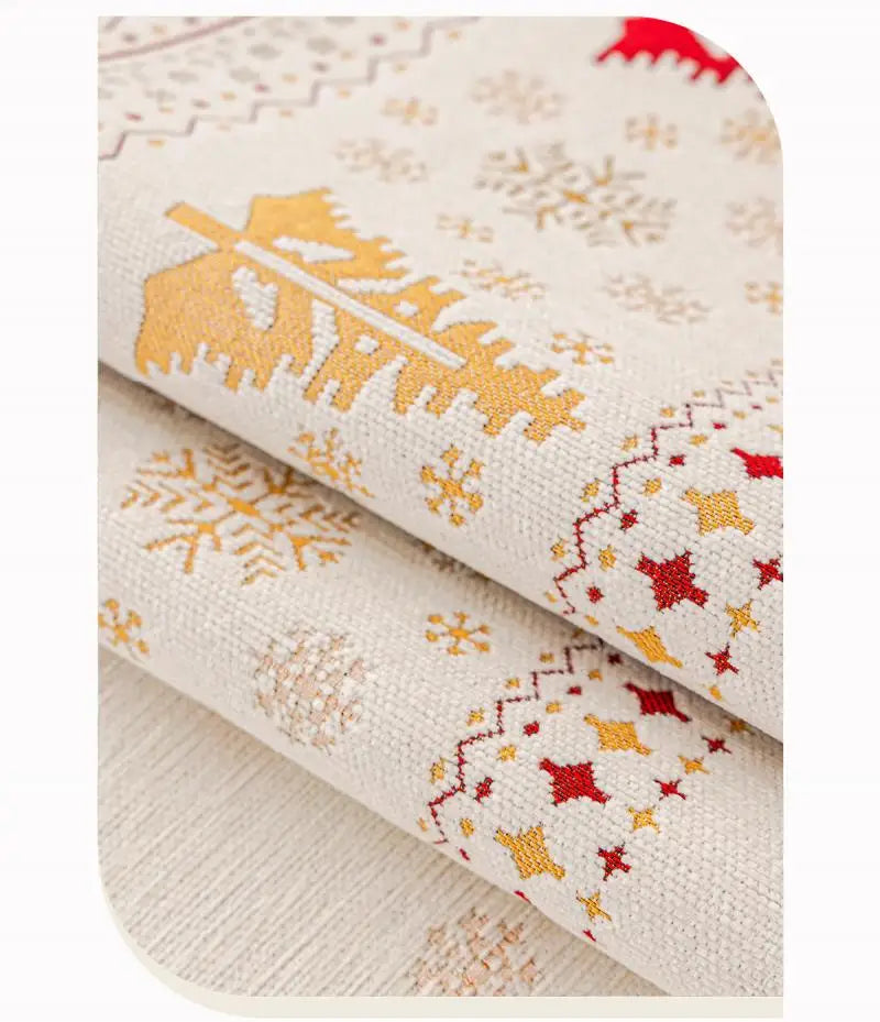 Close-up of beige fabric with gold and red snowflake patterns, showing a rolled sofa seat cover.