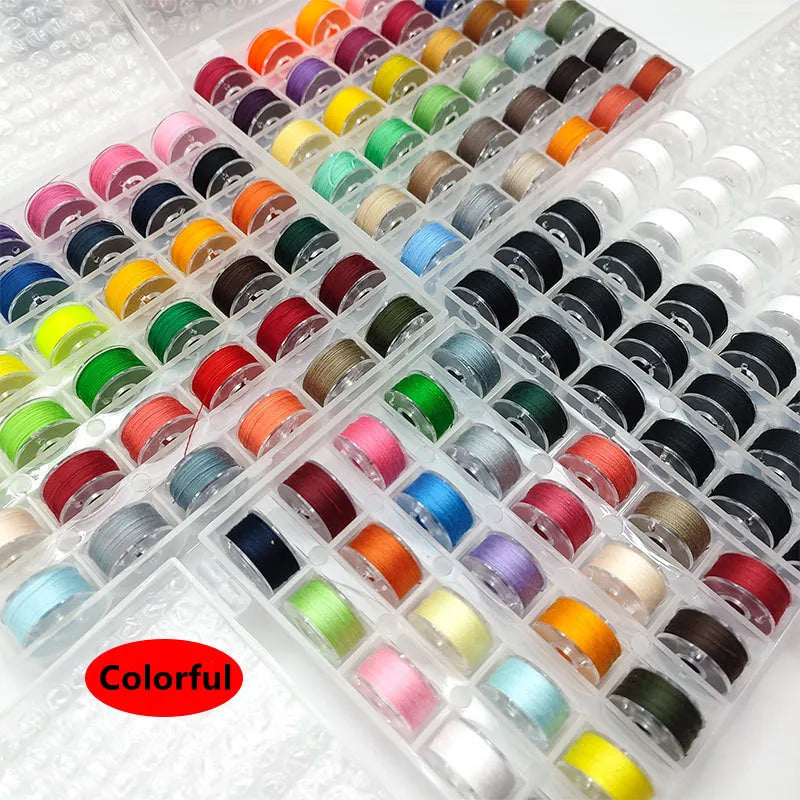 Assortment sewing thread bobbins set showing various colors of thread spools in a clear plastic container