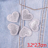 Five glitter iron-on embroidered love heart star patches are displayed on a denim fabric.