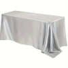 A smooth, silver satin tablecloth draped elegantly on a table.