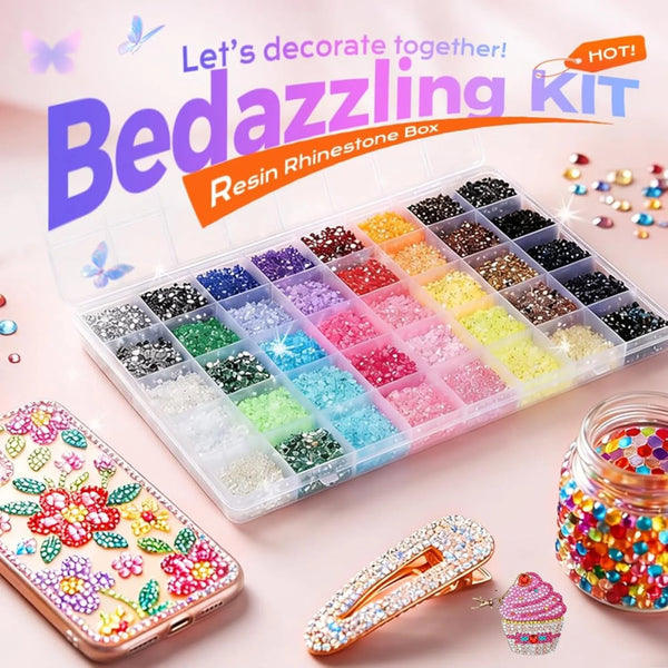 A box of resin and rhinestone materials for crafting, including glitter, beads, and decorative elements.