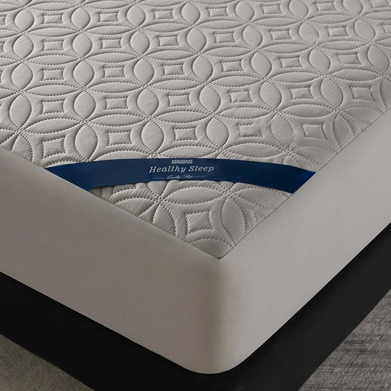 White quilted mattress protector with a blue label reading Healthy Sleep