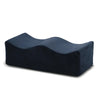 A dark blue ergonomic memory foam leg support pillow.