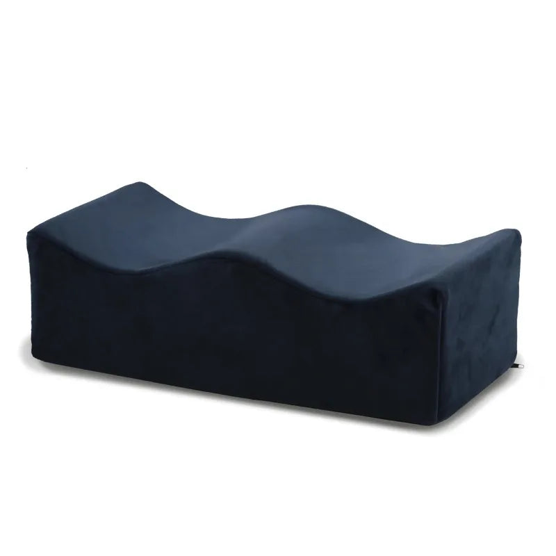 A dark blue ergonomic memory foam leg support pillow.